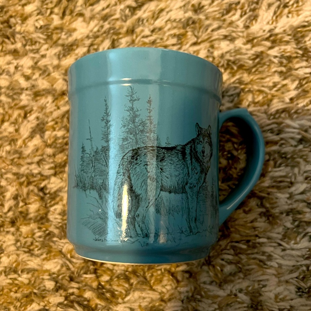 Blueish bass pro shop coffee mug with a wolf on it